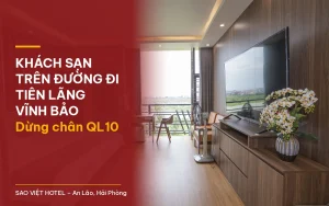 Khách sạn trên đường đi Tiên Lãng Vĩnh Bảo – phòng ốp gỗ có TV lớn, hoa tươi và cửa kính nhìn ra cánh đồng tại Sao Việt Hotel với tiêu đề bài viết