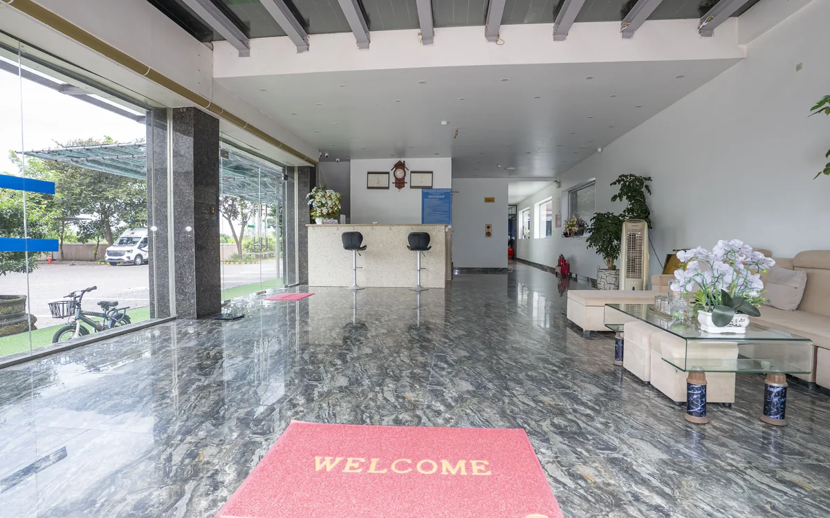Lễ tân khách sạn là gì – sảnh rộng sàn đá, quầy lễ tân, thảm WELCOME và sofa tại Sao Việt Hotel